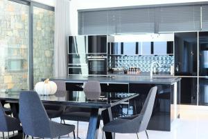 a kitchen with a dining table with chairs and a counter at Casa Blanca in Fethiye