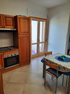 a kitchen with a table and a kitchen with a window at CASA GIOVANNA CASAL VELINO in Casal Velino