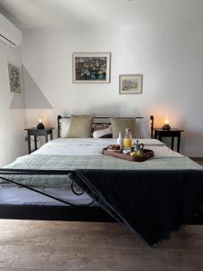 a bed with a tray of food on top of it at Villa Gem in Mravince