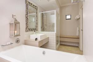 a white bathroom with a sink and a mirror at Harbour House Hotel - Harbour Square in Hermanus