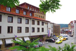 a city street with cars parked next to a building at Yantra Grand Hotel in Veliko Tŭrnovo +114 photos