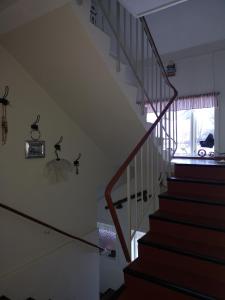 a staircase in a house with a stair case at Elvebakk Bed & Breakfast in Reed