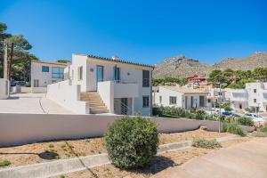 una casa con paredes blancas y un patio en Molins 5, en Cala de Sant Vicent