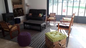 sala de estar con sillas, sofá y mesa en Grande maison avec parc et SPA, en Le Vieux Marillais