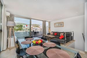 a living room with a table and chairs and a couch at MOLINS 4 in Cala de Sant Vicenc