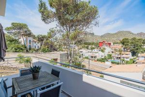a balcony with a table and a view of a city at MOLINS 4 in Cala de Sant Vicent