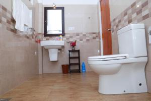a bathroom with a toilet and a sink at Charly Villa in Haburugala +48 photos