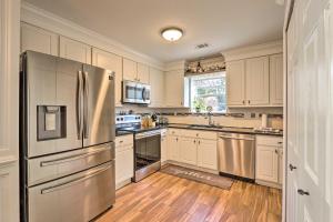 a kitchen with white cabinets and a stainless steel refrigerator at Bluffton Getaway Fenced Yard, 7 Mi to Beach! in Bluffton