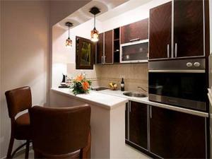 a kitchen with brown cabinets and a counter top at Apartments Twins in Herceg-Novi