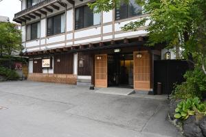 a building with brown doors on the side of it at Ryokan Tamura in Kusatsu
