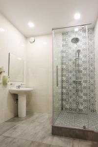 a bathroom with a shower and a sink at Hotel Persona in Abakan