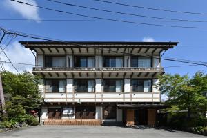 an old building with a balcony on top of it at Ryokan Tamura in Kusatsu