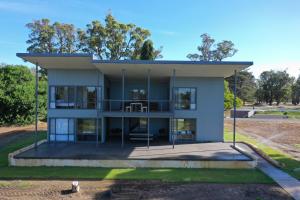 a large house with a porch and a balcony at Stirling Estate Chalets in Capel