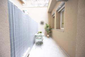 un pequeño balcón con una mesa y una ventana en GetTheKey Lenzi Suites, en Bolonia