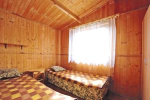 A bed or beds in a room at Bungalow in Mielno in a beautiful setting