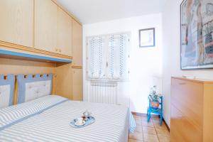 a bedroom with a bed with a stuffed animal on it at Una terrazza sul golfo di Ospedaletti by Wonderful Italy in Ospedaletti