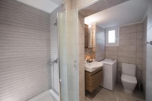 a bathroom with a toilet and a sink and a shower at The Beach House-Valley of love in Episkopos +14 photos
