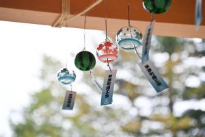 a group of glass ornaments hanging from a ceiling at Ryokan Tamura in Kusatsu