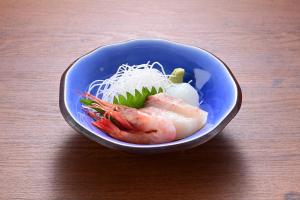 a bowl of food with shrimp and noodles on a table at Ryokan Tamura in Kusatsu