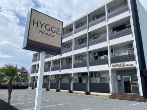 a large building with a sign in front of it at HYGGE Biimata in Nago