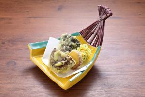 a plate of food on a table with a fork at Ryokan Tamura in Kusatsu