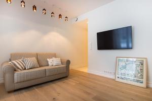 Il comprend un salon doté d'un canapé et d'une télévision à écran plat. dans l'établissement Karusselli Apartment, à Pärnu