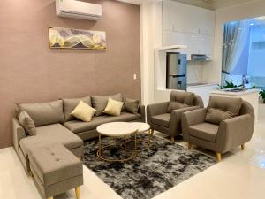 a living room with a couch and two chairs and a table at Royal Hotel Ninh Thuận in Kinh Dinh
