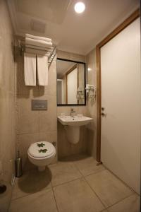 a bathroom with a toilet and a sink at Anita Dream Hotel in Kemer