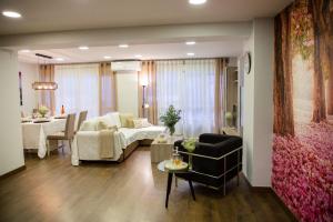 a living room with a couch and a table at LUXURY New Apartment CITY CENTRE & BEACH, Alicante in Alicante