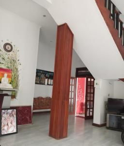 a living room with a large wooden column in the middle at Why Not Palace in Anuradhapura