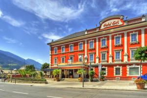 a large orange building on the side of a street at Hotel Ertl & mexican cantina salud in Spittal an der Drau