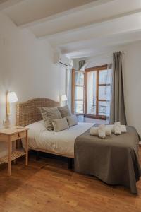 a bedroom with a large bed and a desk at Apartamentos Destino Alquézar in Alquézar