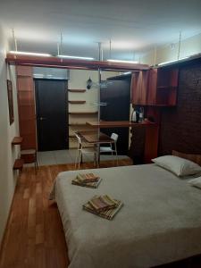 a bedroom with a bed and a table and a desk at SPACE Aparts and Rooms in Yekaterinburg