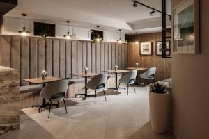 a restaurant with wooden walls and tables and chairs at Amery House in Sliema