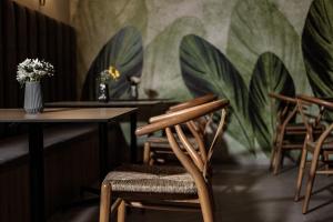 a room with chairs and tables and a mural of plants at Amery House in Sliema