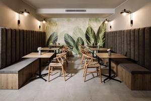 a restaurant with tables and chairs and a mural at Amery House in Sliema