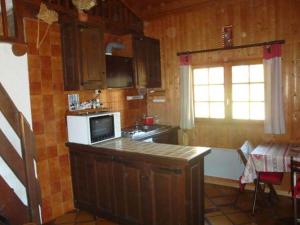 a kitchen with a sink and a stove top oven at Chalet Chez Nous in Domancy