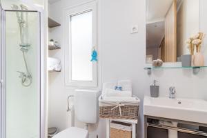 a bathroom with a toilet and a sink and a mirror at Hemy Casa - Lux Mobile Homes in Rovinj +30 photos