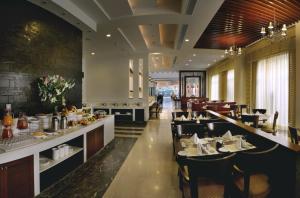 a dining room with tables and chairs in a restaurant at Park Inn Gurgaon in Gurgaon