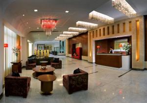 a lobby of a hotel with a table and chairs at Park Inn Gurgaon in Gurgaon
