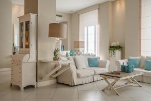 a living room with a couch and a table at Hotel Capri- Adult only in Sorrento