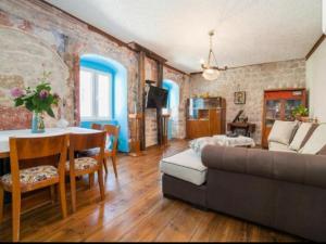 a living room with a couch and a table at Holiday Home Bogumila in Risan