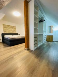 a master bedroom with a bed and a closet at EasyStay#3 Gemütliche Ferienwohnung in Kliniknähe mit Boxspringbett & Netflix in Bad Oeynhausen