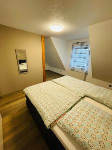a small bedroom with a bed in a room at EasyStay#3 Comfort Suite Ferienwohnung in Kliniknähe mit Boxspringbett & Netflix in Bad Oeynhausen +3 photos