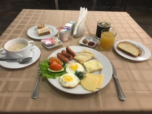 a table with a plate of breakfast food on it at Maldini 1899 Boutique Hotel in Krasnodar