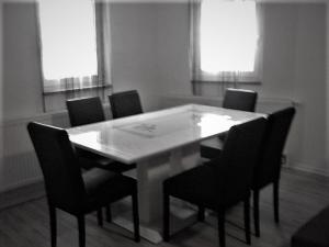 a dining room table with black chairs and windows at Apartment in Rakovica with Wi-Fi (601-3) in Rakovica