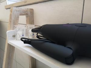a black hair dryer sitting on a table at Villa Caravaggio Comfort e Relax in Rocca San Giovanni