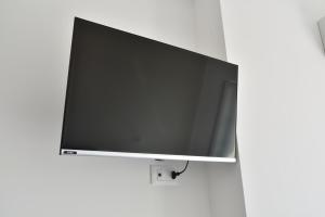 a flat screen tv hanging on a wall at Villa Caravaggio Comfort e Relax in Rocca San Giovanni
