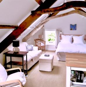 a attic room with two beds and a couch at The Attic Apartment, Quay Street Studios Cardigan in Cardigan