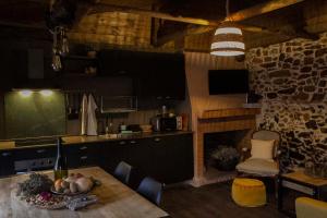 a kitchen with a table with a bowl of fruit on it at RAICES Casa Rural in Torre de Don Miguel